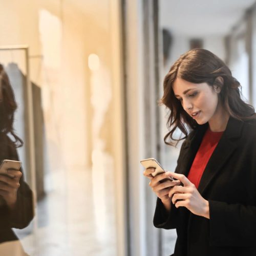 close-up-photo-of-woman-in-black-coat-using-smartphone-787929